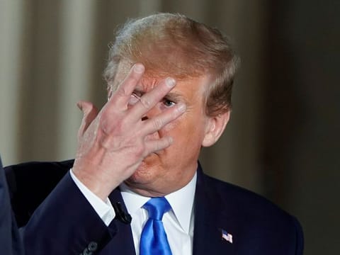 U.S. President Donald Trump gestures as he consults with White House Chief of Staff Mark Meadows during a commercial break as the president participates in a live Fox News Channel virtual town hall called "America Together: Returning to Work" about the response to the coronavirus disease (COVID-19) pandemic being broadcast from inside the Lincoln Memorial in Washington, U.S. May 3, 2020.