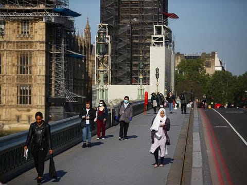 People walk across Westminster Bridge in London following the outbreak of the coronavirus disease (COVID-19), London, Britain, May 6, 2020.