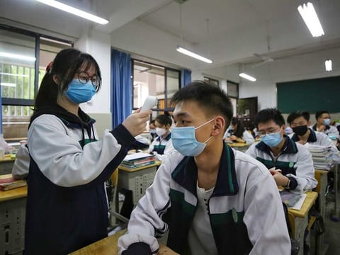 A female student wearing a protective face mask.