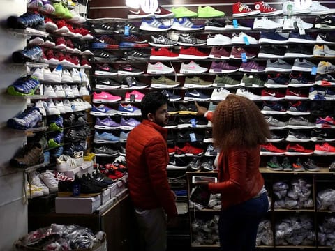 A shopper points at items at a clothing store in Johannesburg, South Africa.