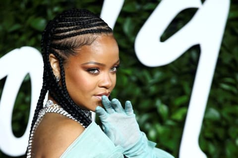 FILE PHOTO: Singer Rihanna poses as she arrives at the Fashion Awards 2019 in London, Britain December 2, 2019. REUTERS/Lisi Niesner/File Photo