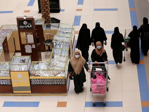 Women shop at a shopping mall after the Saudi government eased a curfew and allowed stores to open, following the outbreak of the coronavirus disease (COVID-19), in Riyadh