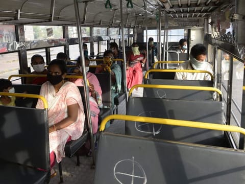 Passengers maintain social distancing as they sit inside a bus as Telangana State Road Transport Corporation (TSRTC) resumed bus services after the government eased lockdown