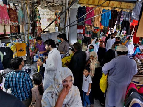People shop for the Eid Al Fitr holiday that marks the end of the Muslim fasting month of Ramadan after the government relaxed a weeks-long lockdown that was enforced to help curb the spread of the coronavirus, at a market in Islamabad, Pakistan, Wednesday, May 20, 2020.
