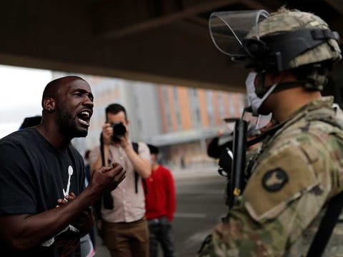 A man confronts a National Guard member guarding the area in the aftermath of a protest against the death in Minneapolis police custody of African-American man George Floyd, in Minneapolis, Minnesota.