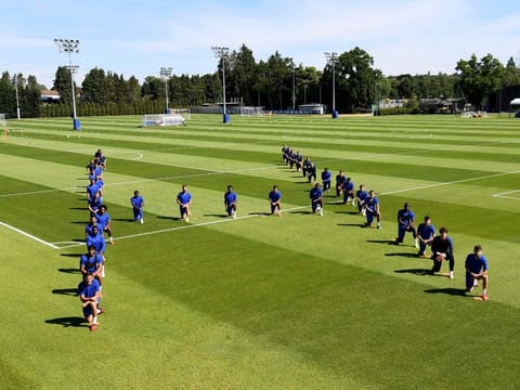 Chelsea FC players pay their tributes to George Floyd before their training session in Cobham, England on Tuesday.