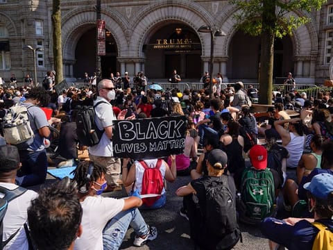Demonstrators gather to protest the death of George Floyd, Wednesday, June 3, 2020, outside of the Trump International Hotel on Pennsylvania Avenue in Washington.