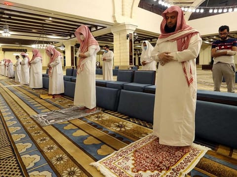 In this file picture, Muslims perform Fajr prayers inside the Al Rajhi Mosque while practicing social distancing.
