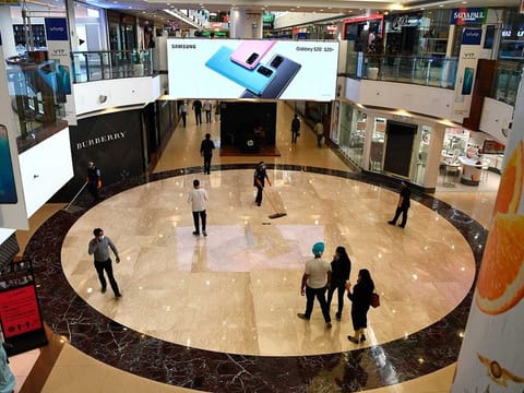 Customers walk inside Select CITYWALK mall after the government eased a lockdown imposed as a preventive measure against the COVID-19 coronavirus in New Delhi, on June 8, 2020.