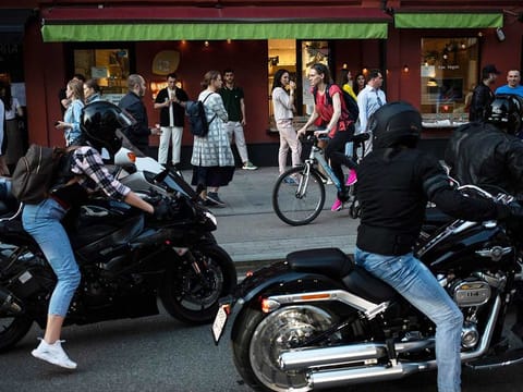 People gather on the street to walk on the last day of lockdown at Patriarch Ponds in Moscow, Russia, Monday, June 8, 2020. The Russian capital is ending a tight lockdown that has been in place for more than two months, citing a slowdown in the coronavirus outbreak.
