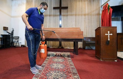 A worker sterilises the National Evangelical Church in Kuwait City on June 11.