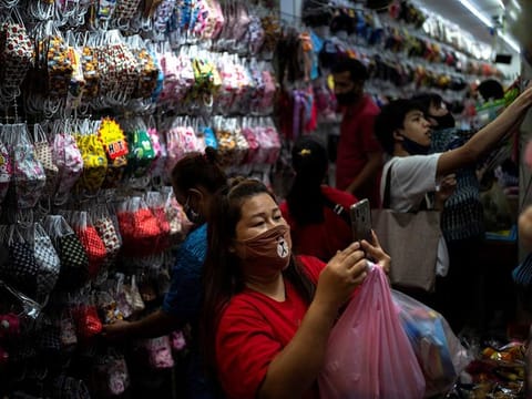 People shop for face masks inside the Sampheng wholesale market as Thai government eases isolation measures, following the coronavirus disease (COVID-19) outbreak, in Bangkok, Thailand, June 10, 2020.