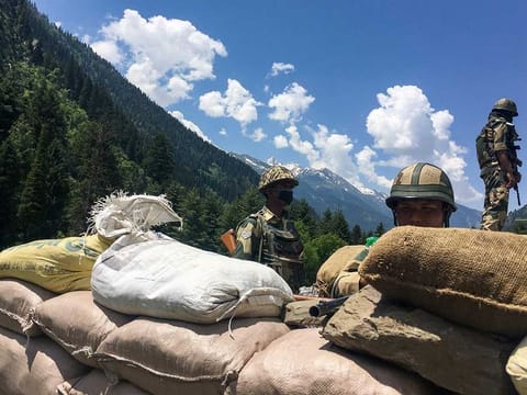 Indian Border Security Force (BSF) soldiers guard a highway leading towards Leh, bordering China, in Gagangir on June 17, 2020. The long-running border dispute between Asian nuclear powers India and China turned deadly for the first time in nearly half a century after at least 20 Indian soldiers were killed in a "violent face-off", the army said on June 16.