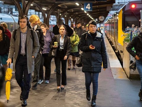 Passengers walk along a platform at Wellington Railway Station in Wellington, New Zealand.
