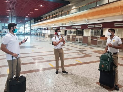 Pakistan cricketers with masks Babar Azam (right), Imad Wasim (left) and Imam-ul-Haq arrive at the Allama Iqbal International airport for their departure to England in Lahore. The squad left for their England tour, but without 10 players who had tested positive for coronavirus.