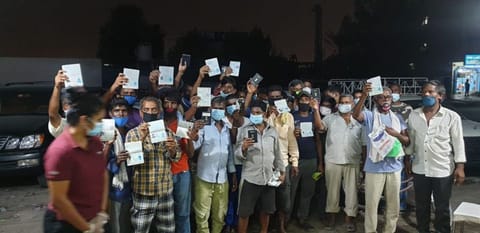 Workers with their recovered passports