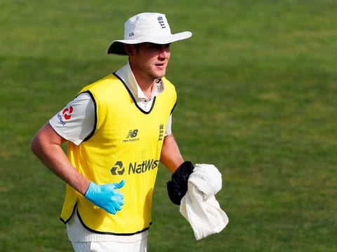 England's Stuart Broad acts as twelfth man on the third day of the first Test cricket match between England and the West Indies at the Ageas Bowl in Southampton, southwest England on July 10, 2020.