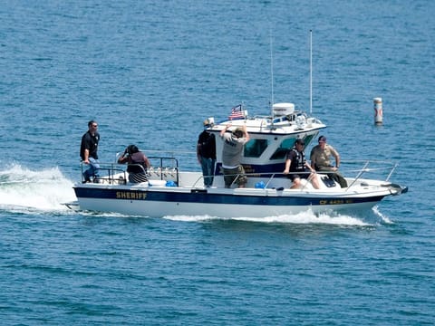 Naya Rivera's father, George Rivera, second from right, and mother Yolanda, second from left, with members of Ventura County Sheriff's Office, are seen in a boat after Naya Rivera's body was found in Lake Piru, Monday, July 13, 2020.