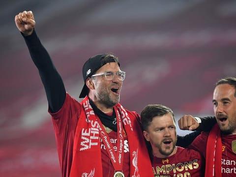 Liverpool manager Jurgen Klopp celebrates with his players after winning the Premier League.