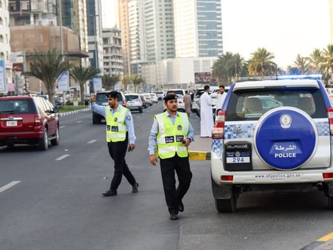 Sharjah police officers managing traffic at Al Noor mosque at Buhairah corniche.