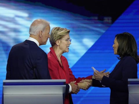 In this September 2019 file photo, from left, Democratic presidential candidate former Vice President Joe Biden, watches as then-candidates Sen. Elizabeth Warren, D-Mass., and Sen. Kamala Harris, D-Calif., shake hands after a Democratic presidential primary debate hosted by ABC at Texas Southern University in Houston.