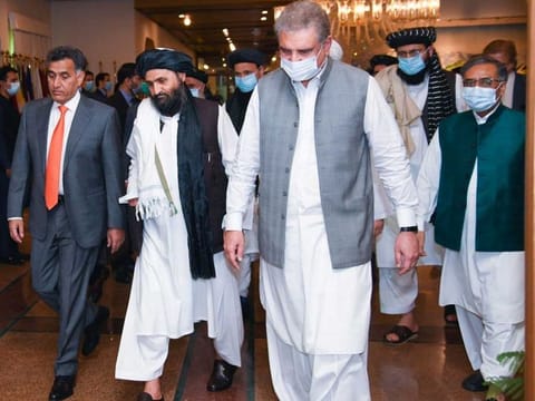 Pakistan's Foreign Minister Shah Mahmood Qureshi walks with Mullah Abdul Ghani Baradar (2nd L), the leader of the Taliban delegation, at the Ministry of Foreign Affairs (MOFA) office in Islamabad, Pakistan last year (File)
