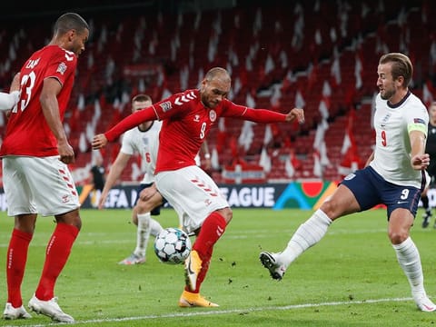 Denmark's Martin Braithwaite (in red) challenges England skipper Harry Kane during their goalless draw in Nations League on Tuesday.