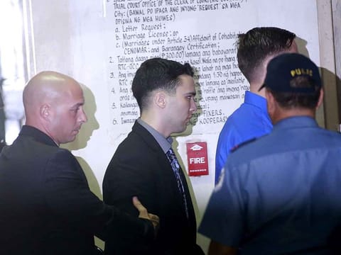 File photo: U.S. Marine Lance Corporal Joseph Scott Pemberton (C) is escorted by U.S. security officers into a court in Olongapo city, north of Manila December 1, 2015