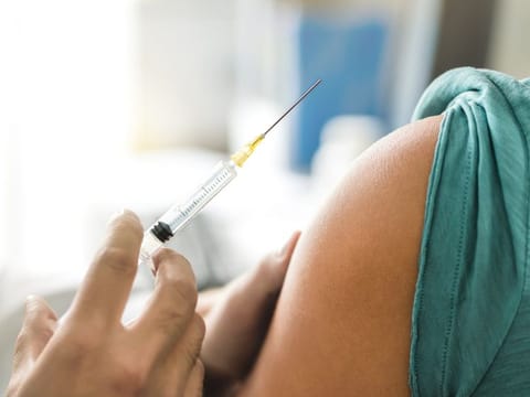 A flu shot being administered to a patient.