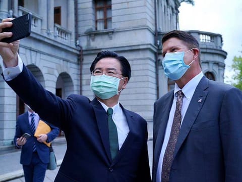 In this photo released by the Taiwan Ministry of Foreign Affairs, Taiwan's Foreign Minister Joseph Wu poses for a selfie with US Under Secretary of State Keith Krach, right, during a meeting in Taipei, Taiwan, Friday, Sept. 18, 2020.