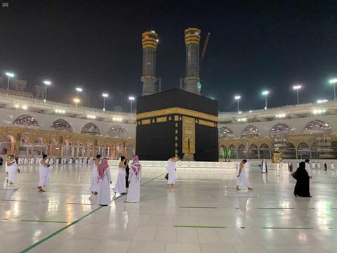 The first group of pilgrims, allowed in the mosque compound by appointment, practice social distancing, as they perform Umrah in the Grand Mosque, after Saudi authorities ease coronavirus (COVID-19) restrictions, in the holy city of Mecca, Saudi Arabia, October 3, 2020.