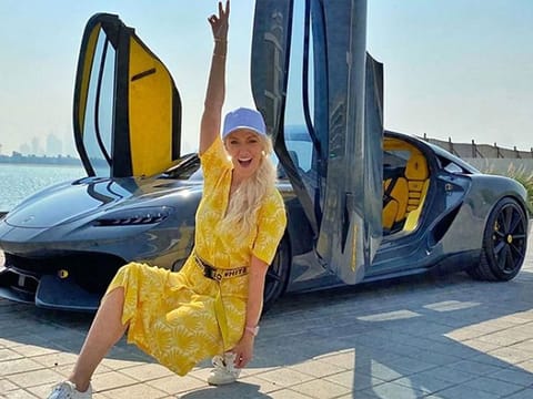 Supercar Blondie with a supercar on one of her photo shoots in Dubai