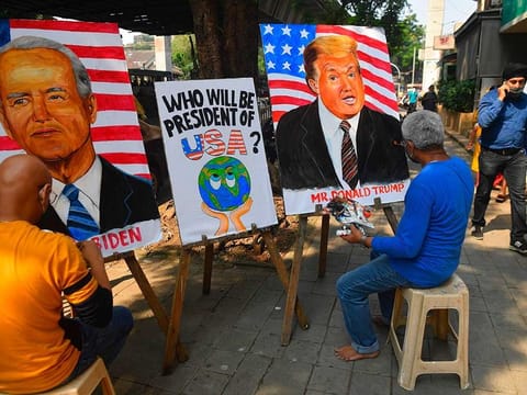 Indian art school teachers paint images of US President Donald Trump and Democratic Presidential Candidate and former US Vice President Joe Biden ahead of the upcoming US presidential elections, outside an art school in Mumbai