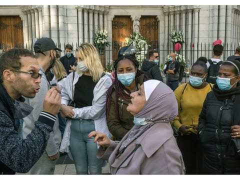 A spirited discussion about religion and politics in front of the Notre Dame basilica in Nice, France, on Friday, October 30, 2020, the day after an assailant carrying a knife entered the building and killed three people.