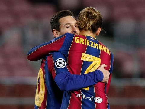 Lionel Messi celebrates scoring Barcelona's first goal with Antoine Griezmann.