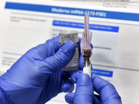 File photo: A nurse prepares a shot as a study of a possible COVID-19 vaccine, developed by the National Institutes of Health and Moderna Inc., gets underway in Binghamton, New York.
