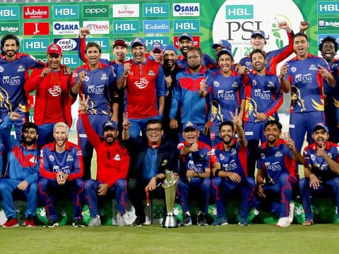 Karachi Kings officials and players pose with the winning trophy after the final of the Pakistan Super League (PSL) T20 cricket match against Lahore Qalandars at National Stadium in Karachi, on November 17, 2020.