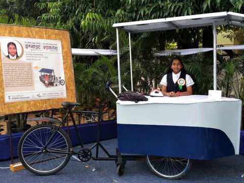 Vinisha Umashankar poses with the solar-powered ironing cart she developed.