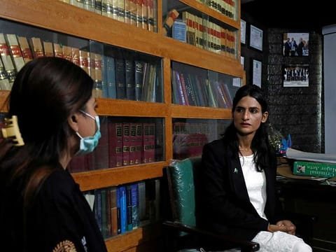 Nisha Rao, 28, a transgender woman who became the country's first practicing lawyer, listens to one of her clients at office in Karachi, Pakistan November 23, 2020.