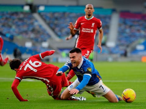 Liverpool's Neco Williams fouls Brighton's Irish striker Aaron Connolly for a penalty