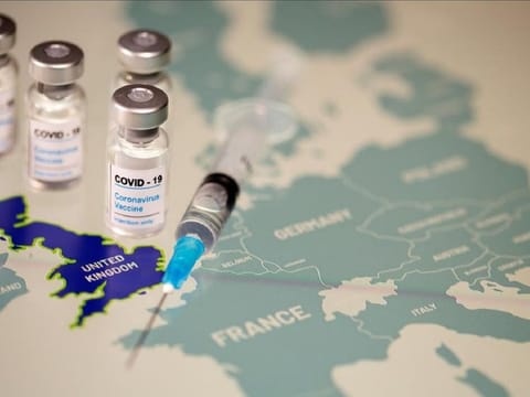 FILE PHOTO: Vials labelled "COVID-19 Coronavirus-Vaccine" and medical syringe are placed on the European Union map in this picture illustration taken December 2, 2020.