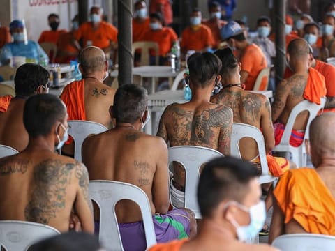 Inmates at the new Bilibid prison wait for their turn to have their tattoo removed in Manila.