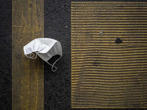 A discarded protective face mask lies on a parking place on November 30, 2020 in Lausanne amid the COVID-19 outbreak, caused by the novel coronavirus.