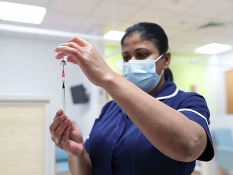 A nurse at the Royal Free Hospital, simulates the administration of the Pfizer vaccine to support staff training ahead of the rollout, in London, on December 4, 2020.