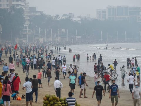 People visit Juhu Beach in the morning hours, in Mumbai, on December 13, 2020.