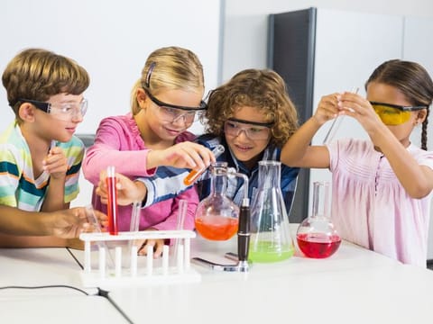 Children enjoying a Science class, experimenting with liquids