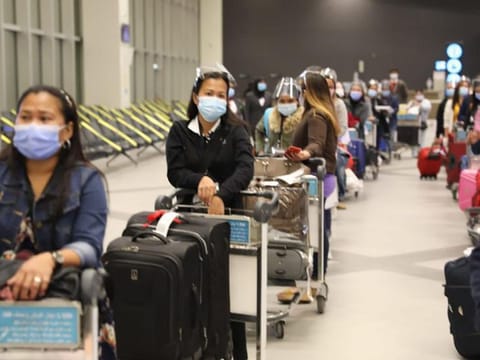 A group of domestic workers arrive at the Kuwait International Airport.