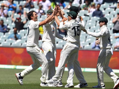 Australia's Pat Cummins (left) celebrates with teammates after dismissing India's captain Virat Kohli on Saturday. India were all out for only 36 runs on the third day of the first Test in Adelaide, their lowest total in Tests.