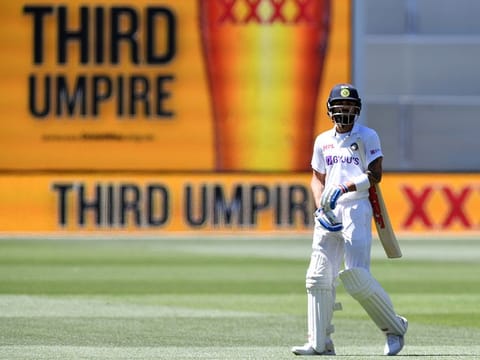 India's Virat Kohli waits as he walks off as the third umpire checks the catch that takes Kohli's wicket for 4 runs against Australia