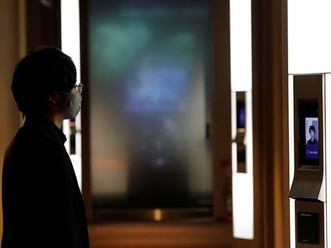 NEC's Shinya Takashima demonstrates a facial recognition system that identifies people even when they are wearing masks, amid the coronavirus disease (COVID-19) outbreak, at its headquarters in Tokyo, Japan.
